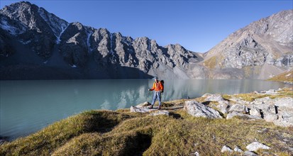 Mountaineers at the turquoise Ala Kul mountain lake, Tien Shan Mountains, Kyrgyzstan, Asia
