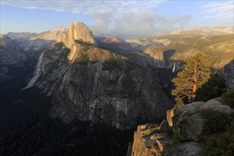 Warm evening light illuminates Half Dome and the surrounding cliffs of Yosemite, Yosemite National