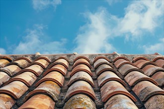 Close up of roof with red ceramic tiles and blue sky. KI generiert, generiert, AI generated