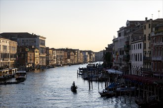 View over the Grand Canal with gondoliers in the evening light, from the Rialto Bridge, Venice,