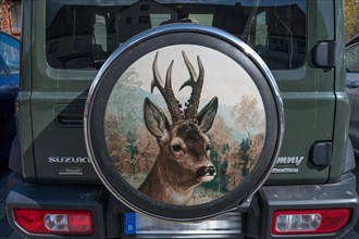 Spare wheel cover on a hunter's car with a painting of a roebuck, Bavaria, Germany, Europe