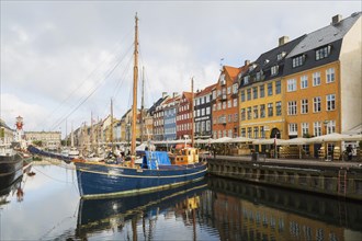 Moored sailboats and colourful 17th century apartment buildings and houses along the Nyhavn canal,