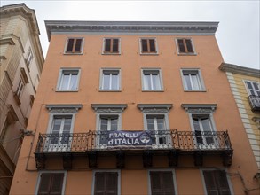 Banner of the political party Fratelli d'Italia, balcony of a house facade, Sassari, Sardinia,
