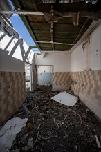 Destroyed abandoned room with tiles full of rubble, ghost town, Engilchek, Tian Shan, Kyrgyzstan,