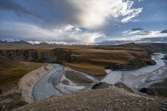 Mountain valley with Sary Jaz river, high glaciated mountain peaks of the Tien Shan in the