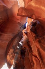 Naturally formed sandstone canyon with light shining through narrow openings, Upper Antelope