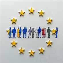 Colourful paper figures representing the diverse community of Europe, surrounded by EU stars, AI