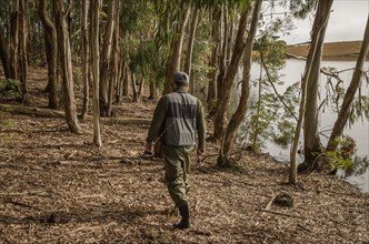 Sport fisherman fishing in lake on cloudy day, Cambara do sul, Rio Grande do sul, Brazil, South