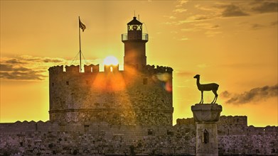 Warm sunlight shines through the windows of a lighthouse on an old castle wall, sunrise, dawn,