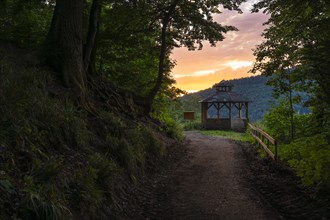 The Bockfelsenhuette refuge in the Little Odenwald at sunset. The forest path is part of the