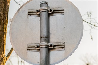 Backside of round traffic sign mounted on metal pole in South Korea