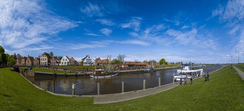 Fishing boats, excursion ship 'Graf Edzard I' and historic houses at Greetsiel harbour, panoramic