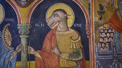 St Christopher with dog's head, church fresco with an animal-shaped figure in religious clothing