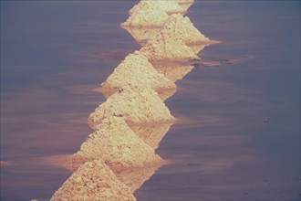 Close up view of the heaps of salt forming a pyramid and arranged in rows during the harvest season