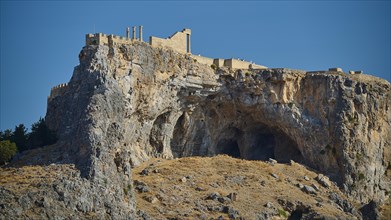 Acropolis of Lindos, Temple of Athena Lindia, An ancient fortress on a steep cliff under a clear