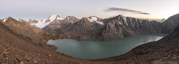 Panorama, Turquoise mountain lake Ala Kul Lake, Mountain peaks with glaciers at dusk, Ala Kul Pass,