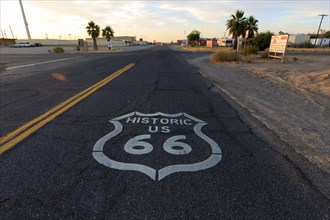 View of historic Route 66 at sunset with road markings and desert landscape, Historic Route 66,