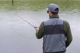 Black bass fisherman fishing inside lake, Cambara do sul, Rio Grande do sul, Brazil, South America