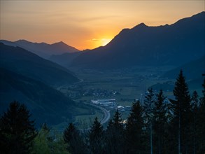 Sunset over mountain peaks, in the valley the village of Traboch, Schoberpass federal road, view