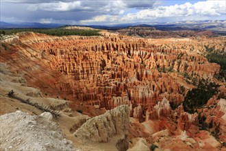 Panoramic view of a vast eroded rocky landscape with dramatic sky, Bryce Canyon National Park,