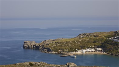 Coastal view with white architecture on the edge of a quiet bay, Lindos, Rhodes, Dodecanese, Greek