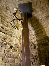 Representation with artificial skeleton of historical torture in former torture cellar of 13th