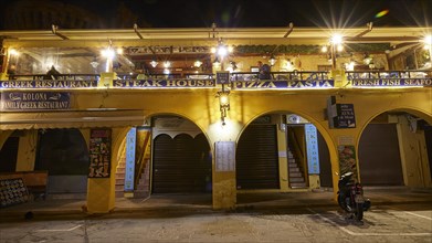 The facade of a restaurant at night, round arches, night shot, Rhodes Old Town, Rhodes, Dodecanese,