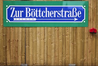 Signpost to Boettcherstrasse on a wooden fence in Bremen, Hanseatic City, State of Bremen, Germany,