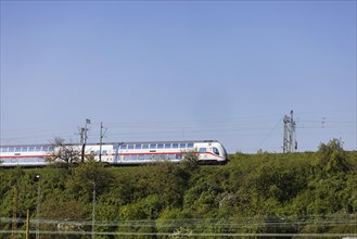 Deutsche Bahn AG InterCity en route, railway embankment and overhead lines, infrastructure,