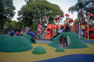 Children playing on a playground in a public park in Buenos Aires, Argentina, South America