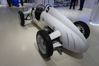 POLENSKY MONOPOLLETTA, White, open monoposto racing car in a car museum, sporty vintage style,