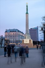 Freedom Monument, Mila holding three golden stars, behind it Radisson Hotel, Riga, Latvia, Europe