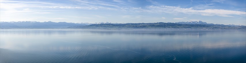 Lake Constance in the early morning, no boats on the lake yet, deserted. In the background the