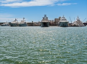 View of the marina of Tarragona with luxury yachts, clear blue sky and calm sea, Tarragona, Spain,