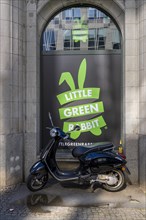 Scooter in front of a window with advertising, Berlin, Germany, Europe