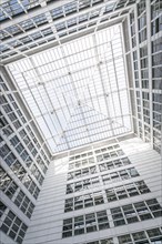 View upwards through a glass roof to the clear sky with geometric patterns, Berlin, Germany, Europe