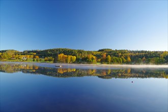 Autumn morning mist over a calm lake, foliage colouring, Bullaren, Bohuslaen. Sweden