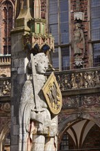 Head, sword and coat of arms of the Bremen Roland against the facade of the historic Bremen Town