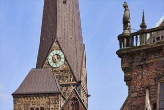 Tower clock of the Church of Our Lady with a figure on the roof of the historic Bremen Town Hall in