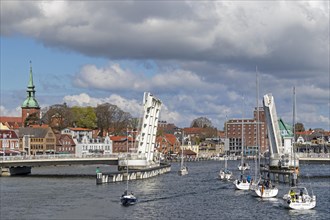 Sailing boats pass through open bascule bridge, Kappeln, Schlei, Schleswig-Holstein, Germany,