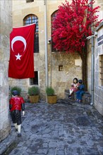 Doll mannequins and Turkish flag in a narrow street, Gaziantep, Turkey, Asia