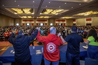 Chicago, Illinois, Shawn Fain (second from left), president of the United Auto Workers union, joins