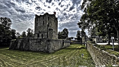 Photo in style of old historical postcard of ruins of former moated castle with in the centre