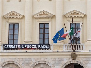Call for peace, flags, neoclassical Palazzo della Provincia, Piazza Italia, Sassari, Sardinia,