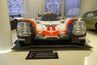 PORSCHE 919 HYBRID LMP1 MOCK-UP, White and red Porsche Hybrid racing car in the museum with sponsor