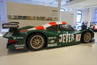 A green and black painted Zakspeed racing car with sponsor logos in the museum, AUTOMUSEUM