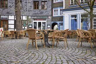 Seating groups in the outdoor area of restaurants from a frog's-eye view on the church square in
