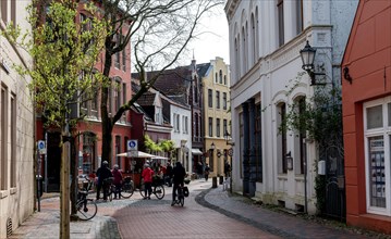 Cyclist in the Kirchstrasse, Old Town, City of Leer, East Frisia, Lower Saxony, Germany, Europe