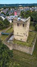 Aerial view of historic ruins of former moated castle with 12th century Romanesque residential