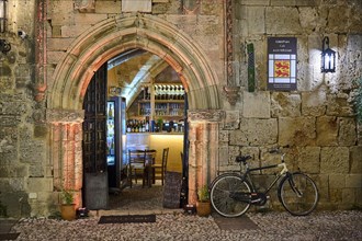Rustic scene with a bicycle in front of a wine bar at night, night shot, Rhodes Old Town, Rhodes,